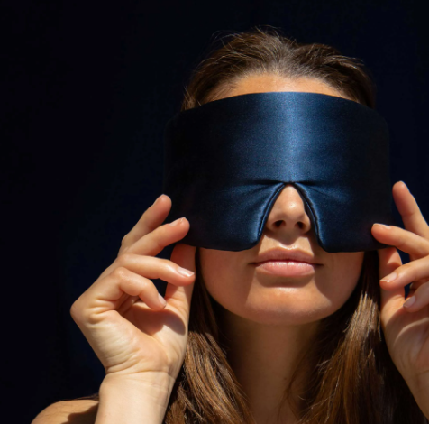 Vrouw met deluxe groot blauw zijden oogmasker voor ultieme ontspanning